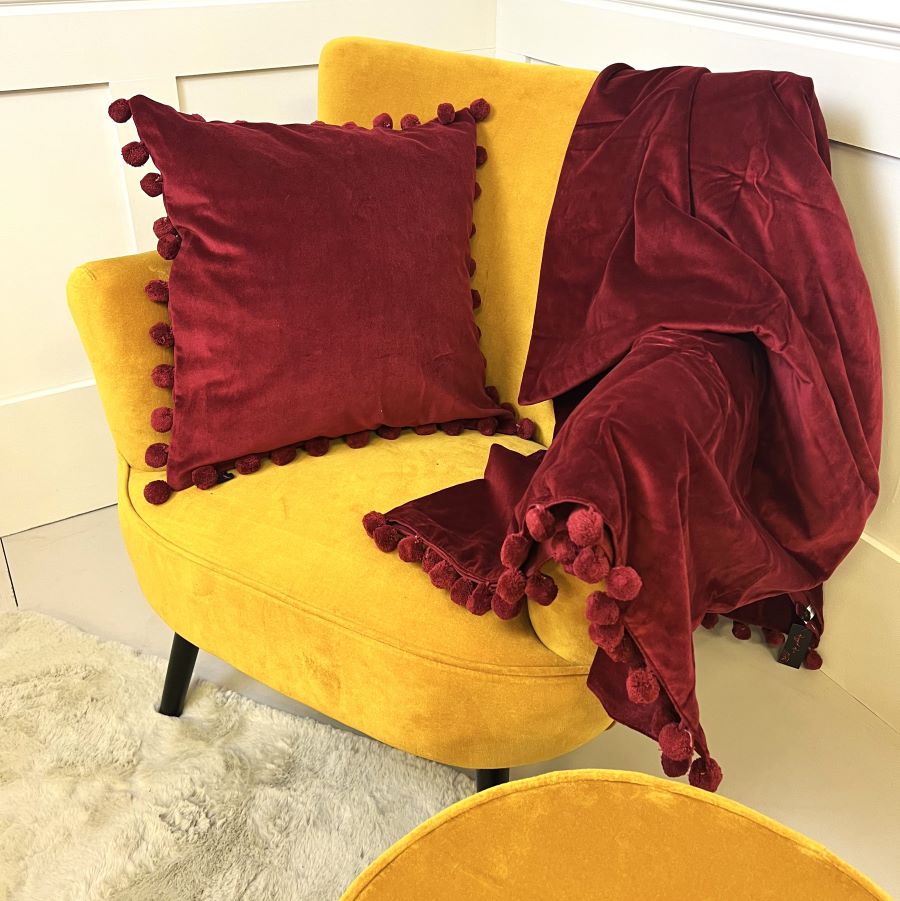 red velvet pompom cushion
