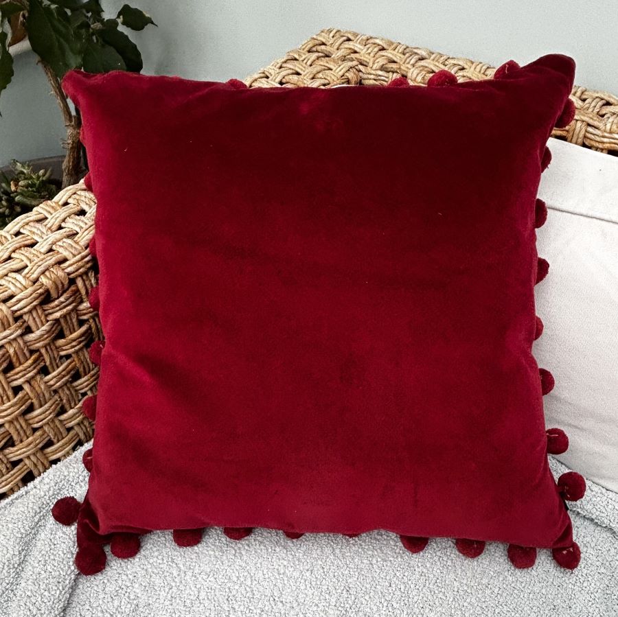 red velvet pompom cushion