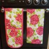 tracy pink rose tea towel on cooker